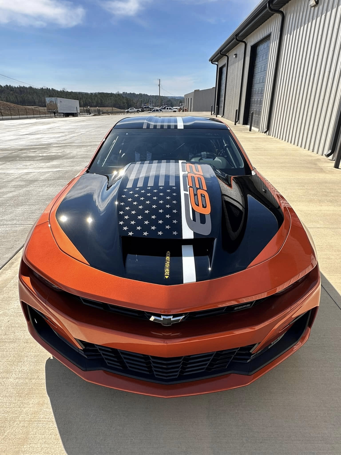 car detailing in Longview by SE Auto Solutions — Orange Camaro 2SS — hood and stripe presentation with crisp exterior finish, Longview