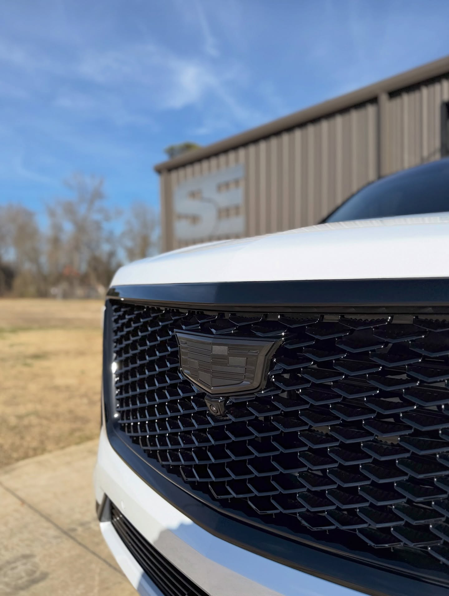 car detailing in Longview by SE Auto Solutions — White Cadillac Escalade — front grille detail and finish, Longview