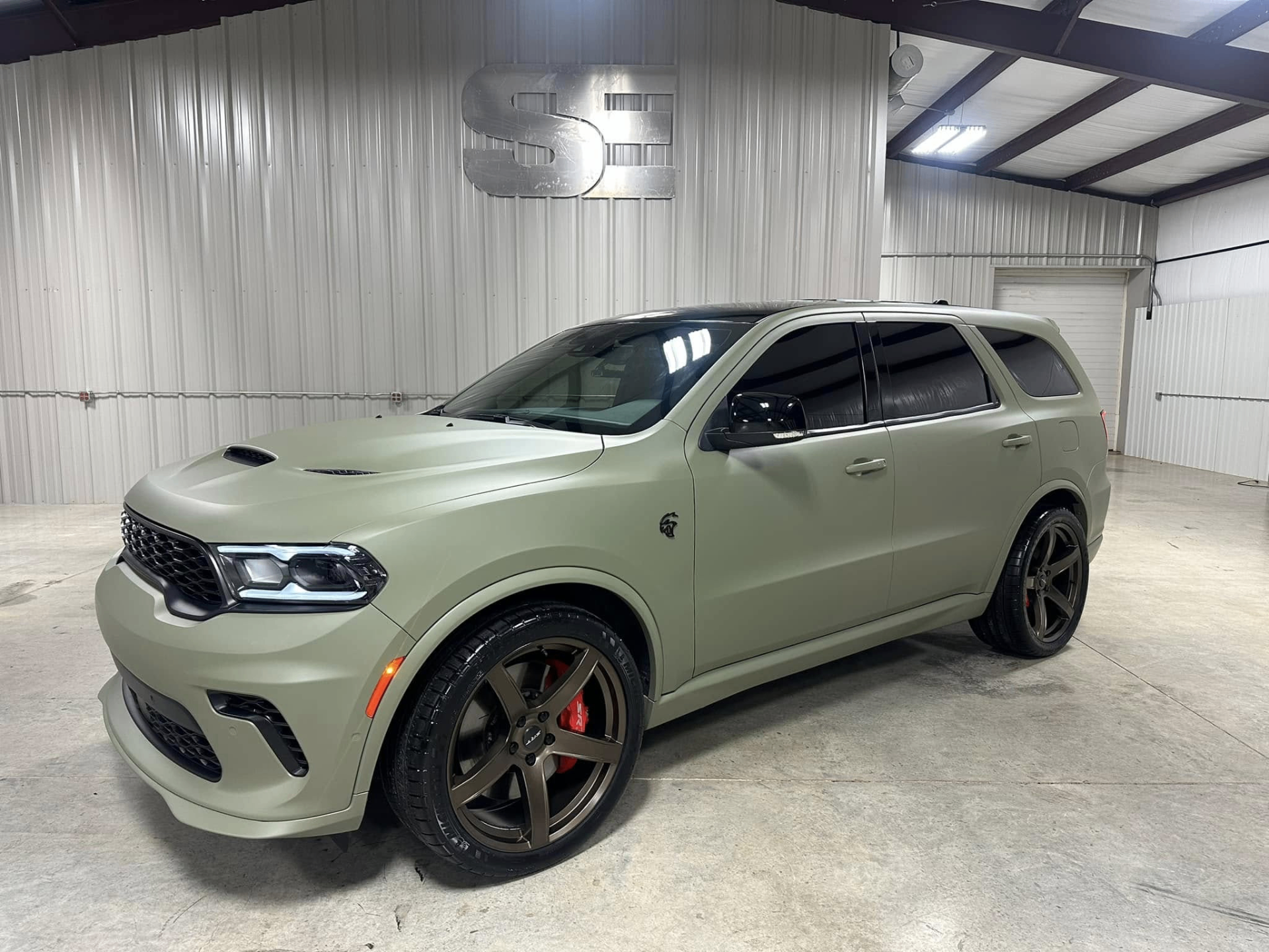 car detailing in Longview by SE Auto Solutions — Matte green Dodge Durango Hellcat — premium finish inside the SE shop, Longview