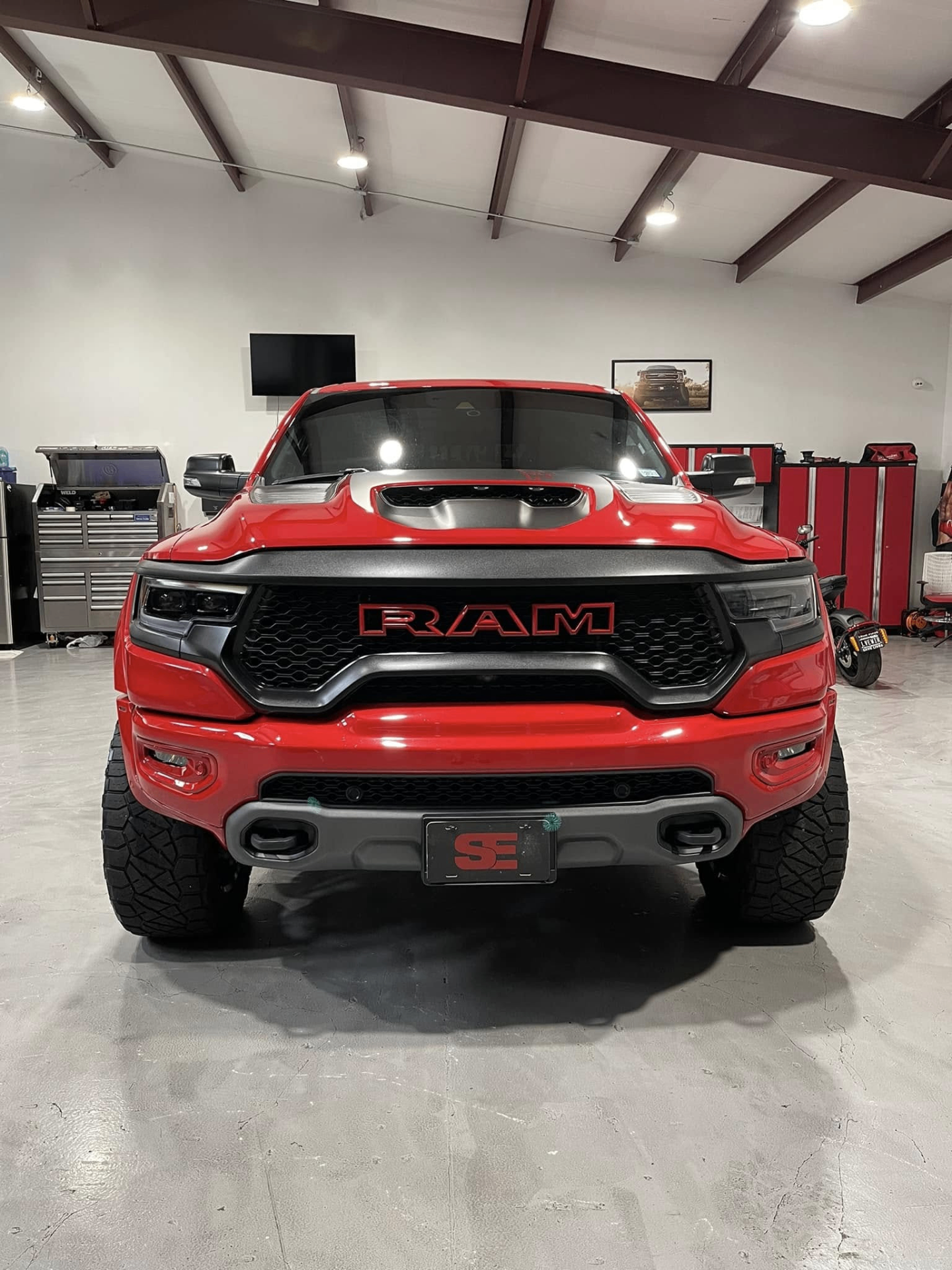car detailing in Longview by SE Auto Solutions — Red RAM TRX — aggressive front-end detail under shop lighting, Longview