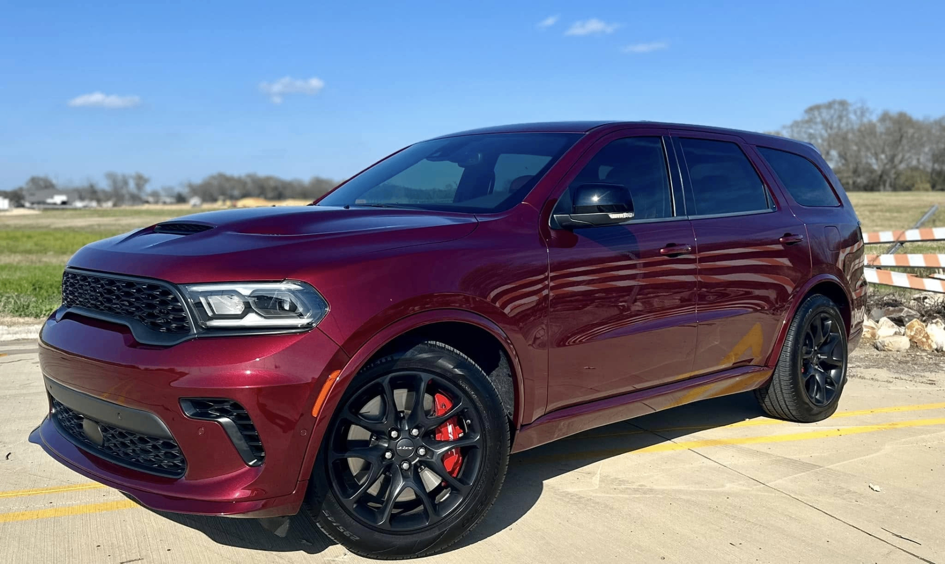 car detailing in Longview by SE Auto Solutions — Deep red Dodge Durango SRT — high-gloss exterior finish in natural light, Longview