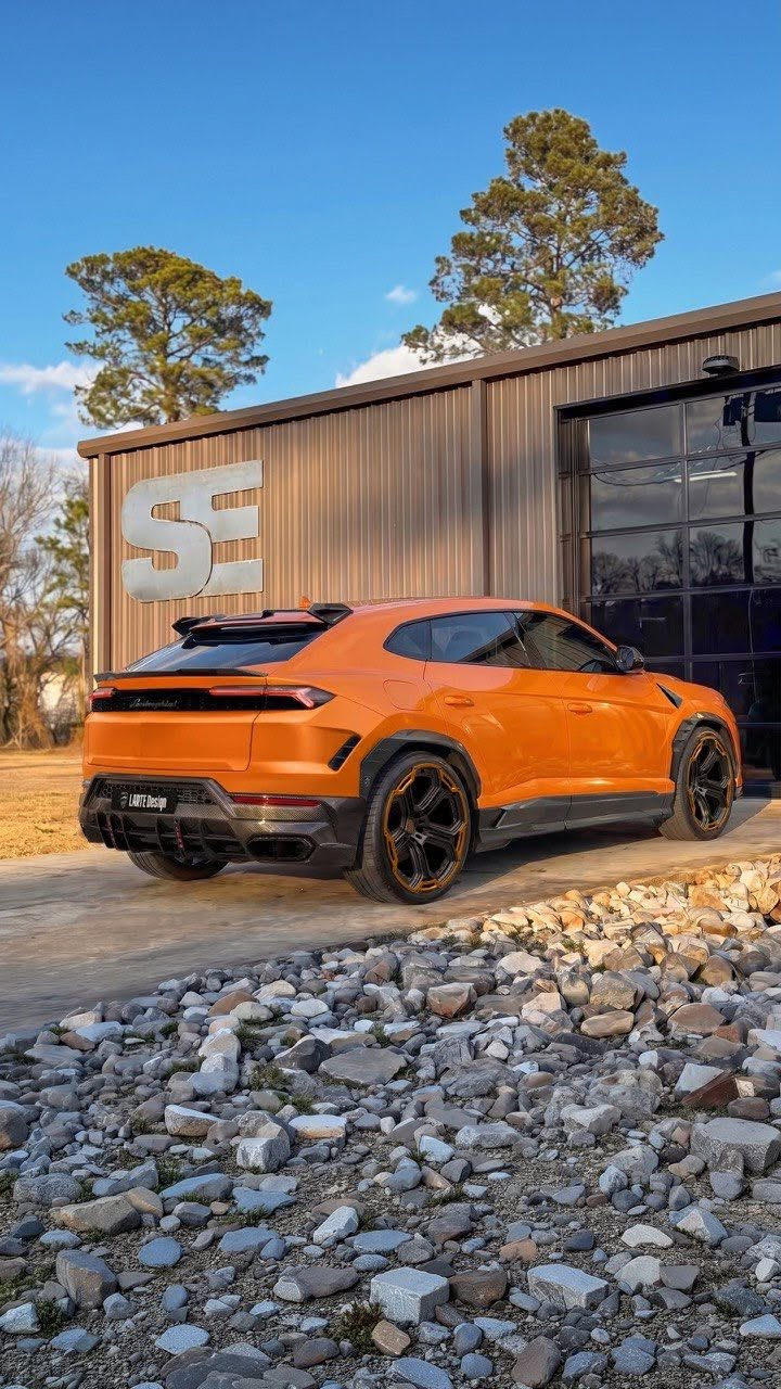car detailing in Longview by SE Auto Solutions — Lamborghini Urus widebody in orange — rear-quarter gloss detail at the SE shop, Longview