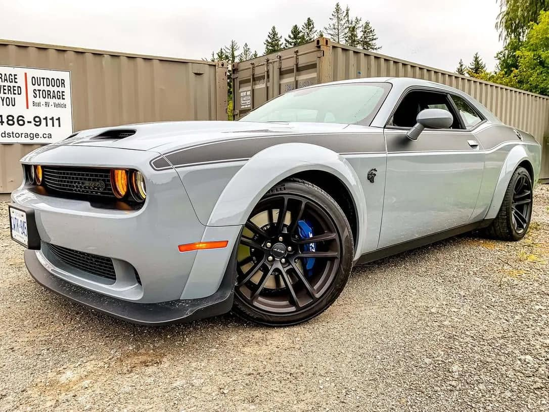 car detailing in Longview by SE Auto Solutions — Gray Dodge Challenger Hellcat with stripe — high-gloss exterior finish, Longview