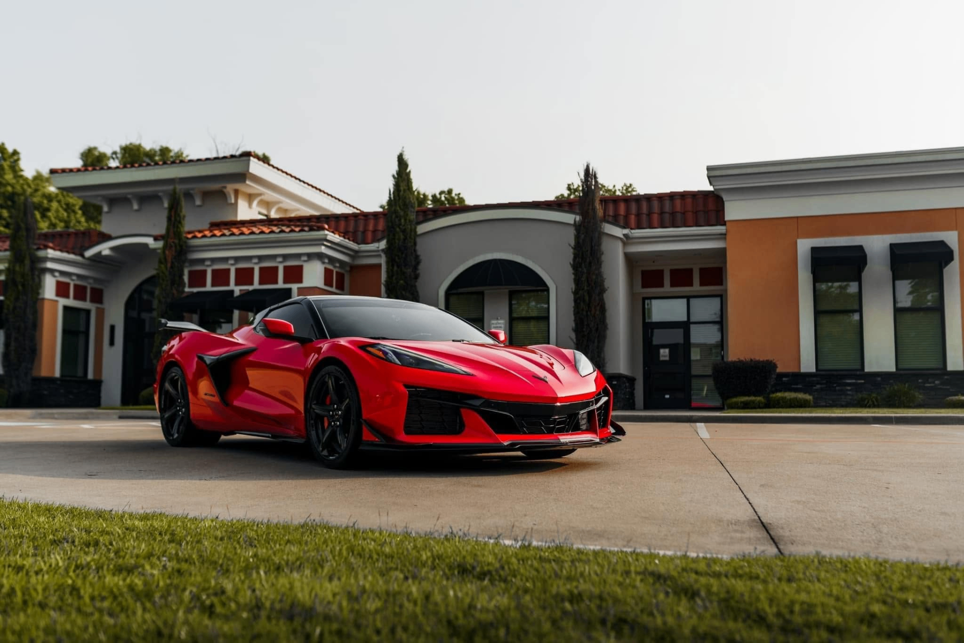 car detailing in Longview by SE Auto Solutions — Red Chevrolet Corvette Z06 — show-finish detail outside the shop, Longview