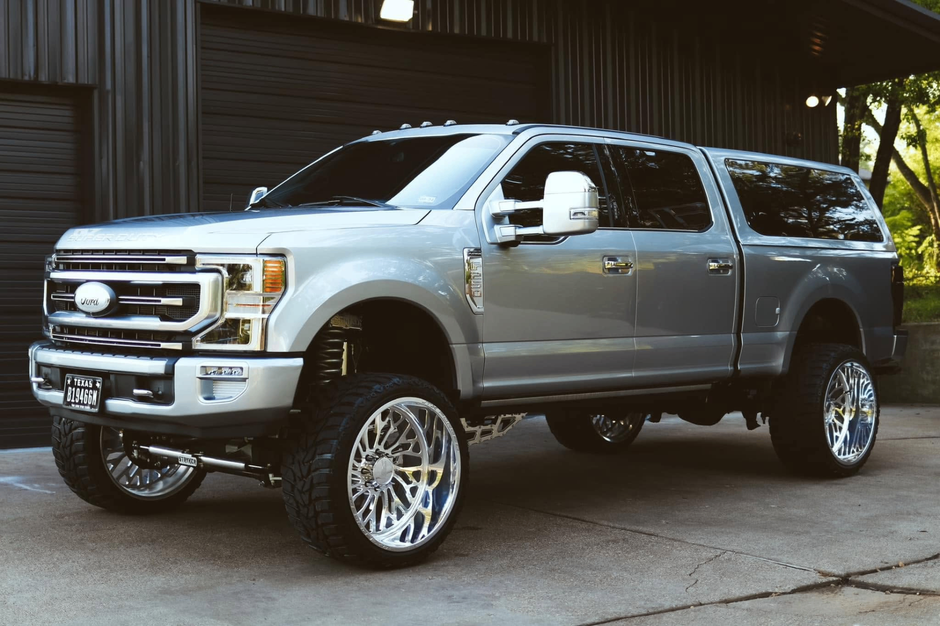 car detailing in Longview by SE Auto Solutions — Silver Ford Super Duty with canopy and polished wheels — custom truck detail, Longview