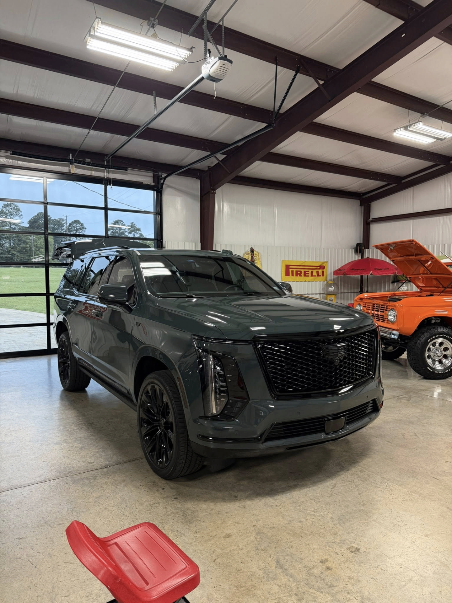 car detailing in Longview by SE Auto Solutions — Gray Cadillac Escalade — glossy showroom-ready finish inside the SE shop, Longview