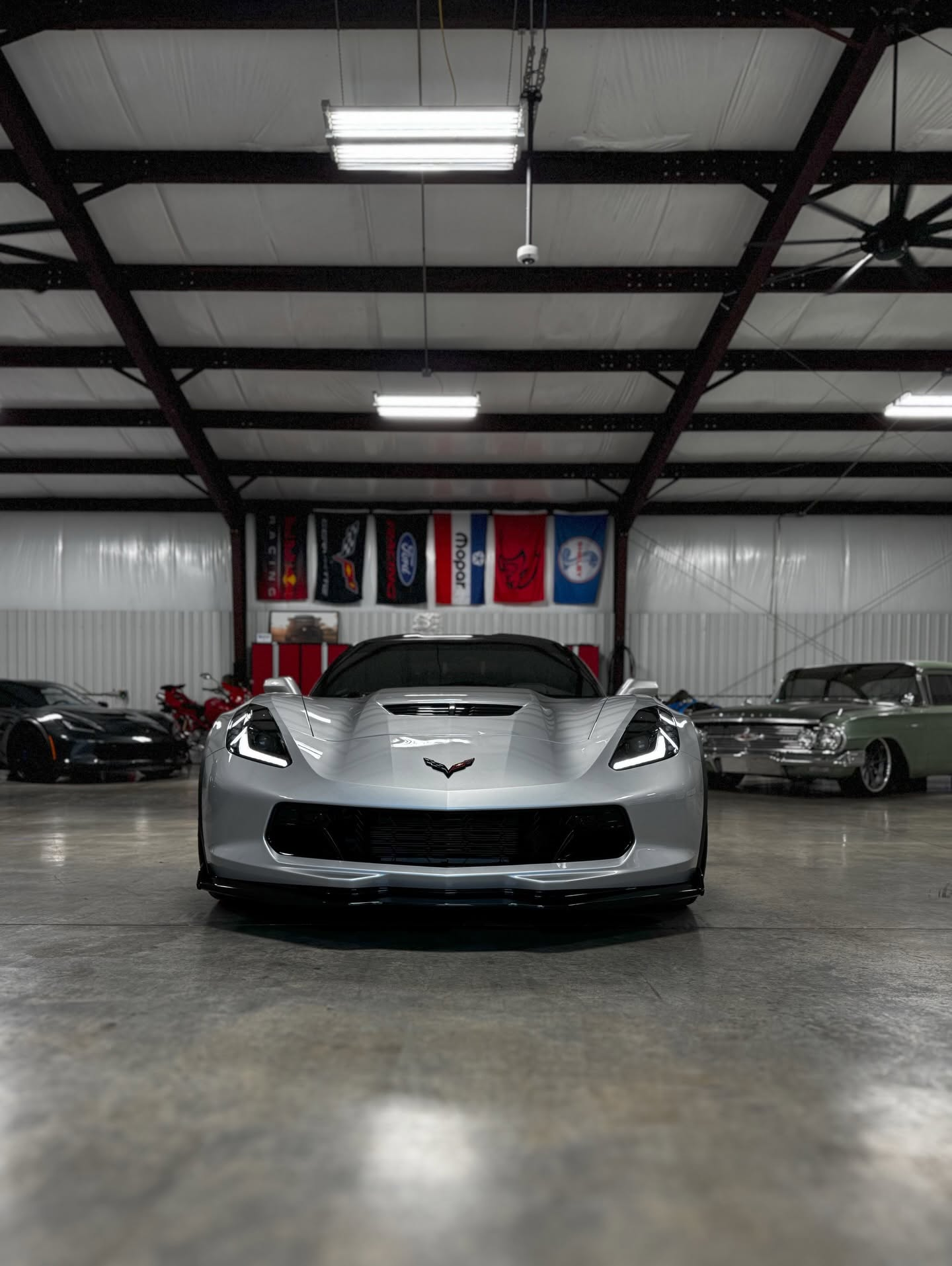 car detailing in Longview by SE Auto Solutions — White Corvette — front-end show finish under shop lighting, Longview