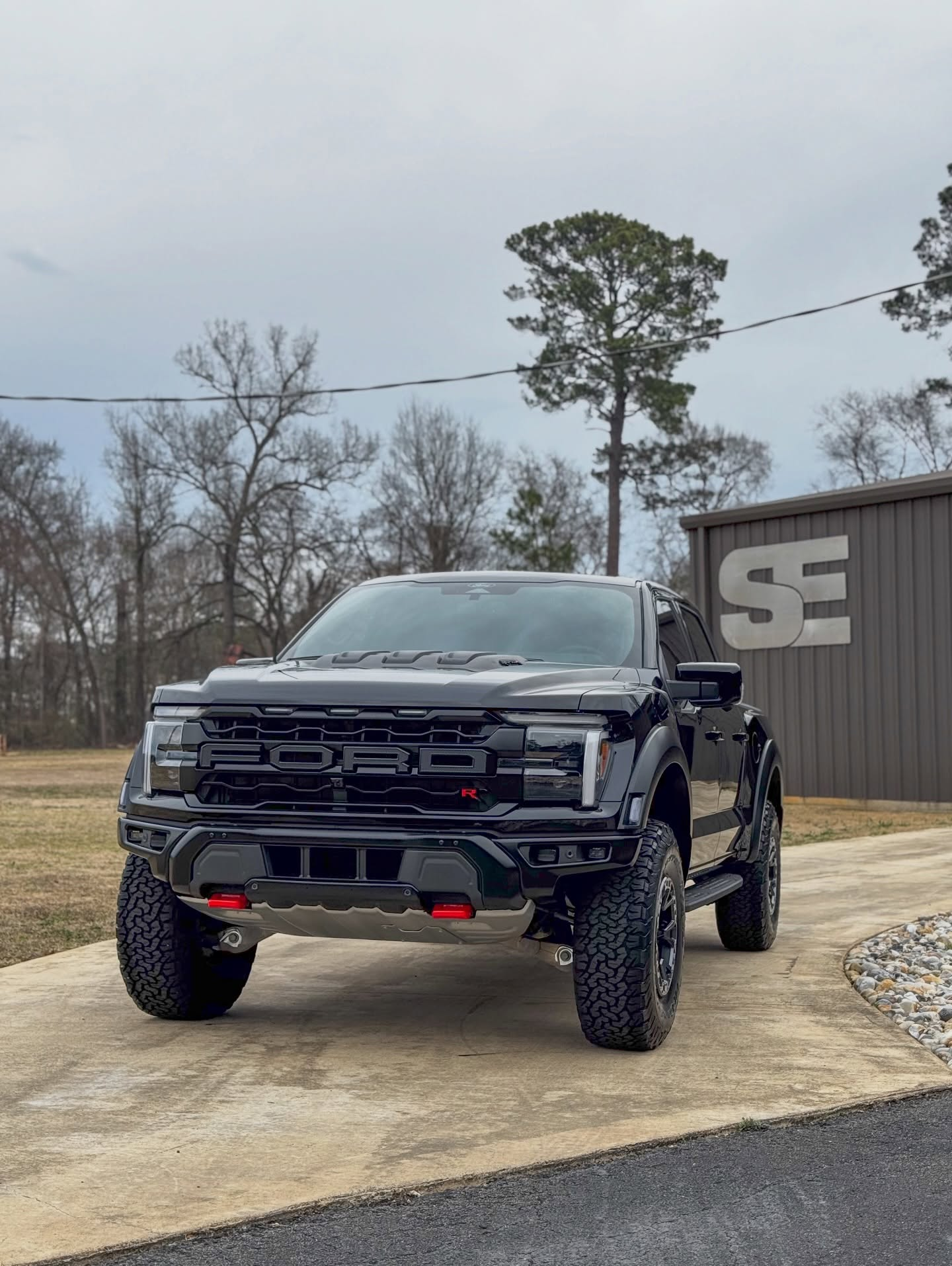 car detailing in Longview by SE Auto Solutions — Black Ford Raptor R — exterior detail and gloss finish outdoors, Longview